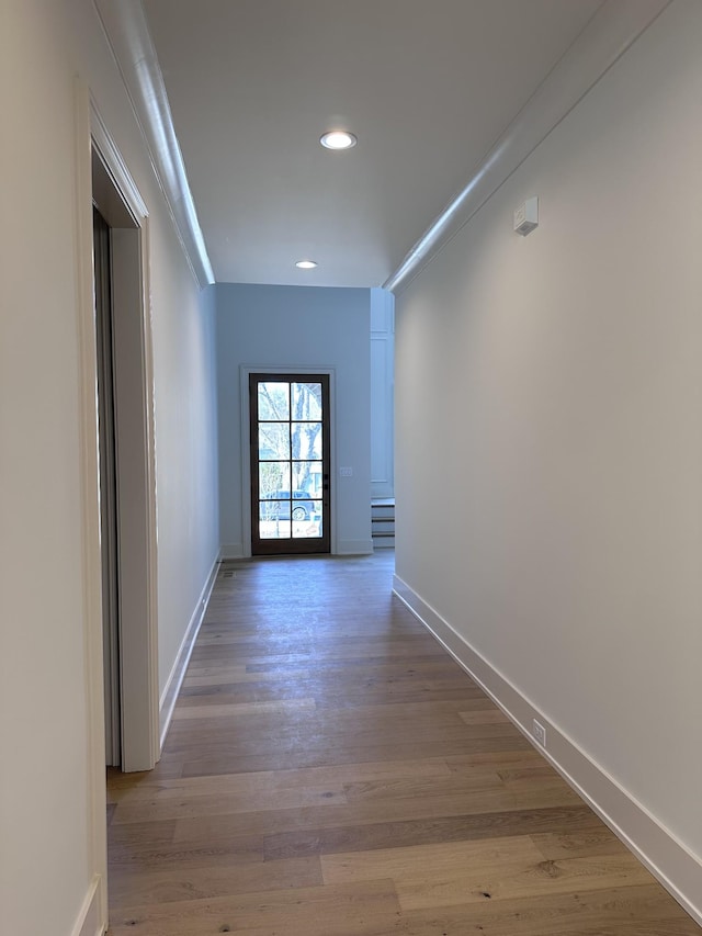 hall featuring ornamental molding and hardwood / wood-style flooring