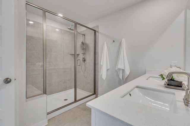 bathroom featuring tile patterned flooring, vanity, and walk in shower