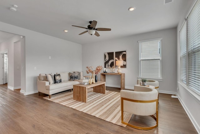 living room featuring ceiling fan and light wood-type flooring