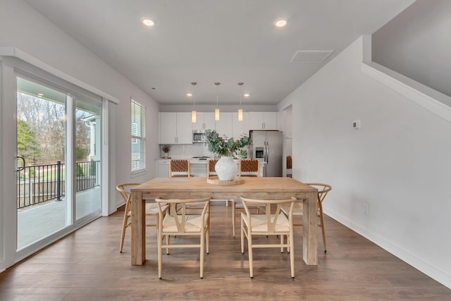 dining area with hardwood / wood-style floors