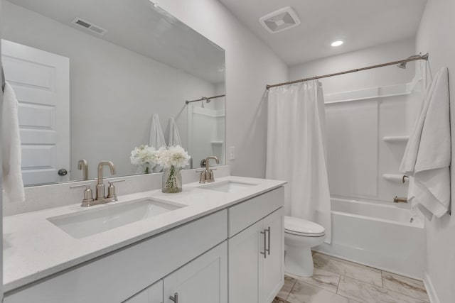 full bathroom featuring shower / bath combo with shower curtain, vanity, and toilet