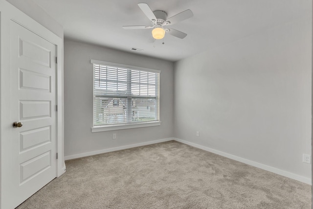 unfurnished room featuring ceiling fan and light colored carpet