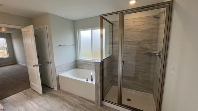 bathroom with shower with separate bathtub