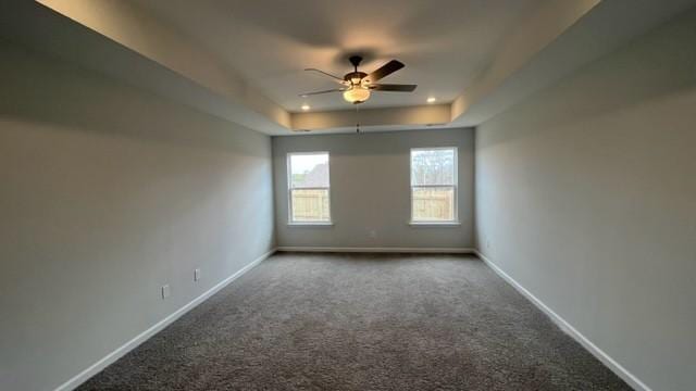 unfurnished room featuring carpet flooring, ceiling fan, and a tray ceiling