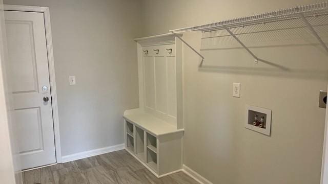 laundry area featuring electric dryer hookup, washer hookup, and wood-type flooring