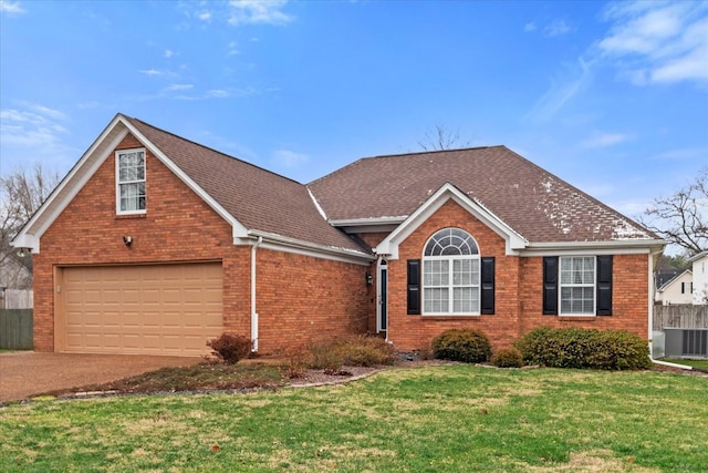 view of front of property featuring cooling unit, a garage, and a front yard