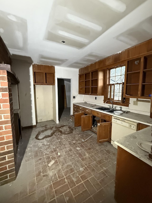 kitchen featuring a fireplace, dishwasher, and sink