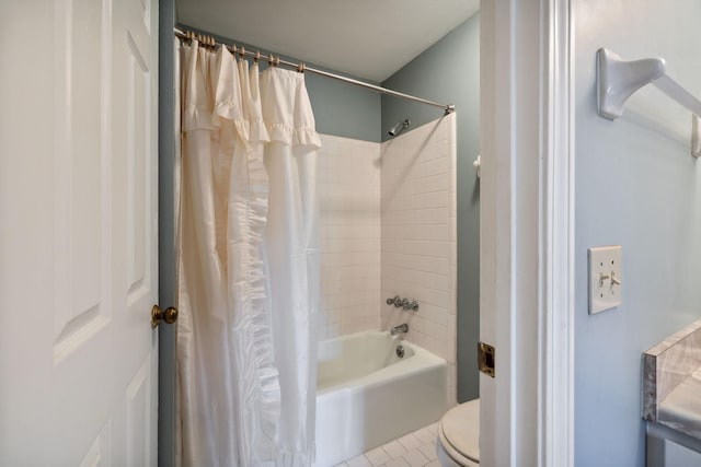 bathroom with tile patterned floors, toilet, and shower / bath combo with shower curtain