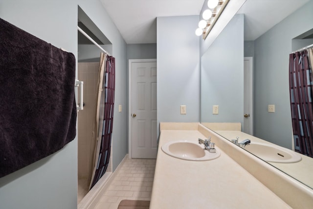 bathroom with a shower with shower curtain, vanity, and tile patterned floors