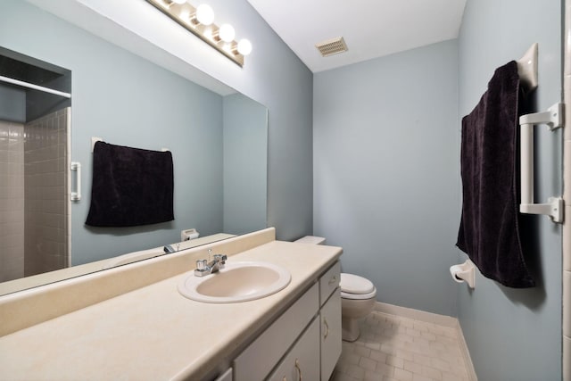 bathroom featuring tile patterned flooring, a shower, vanity, and toilet