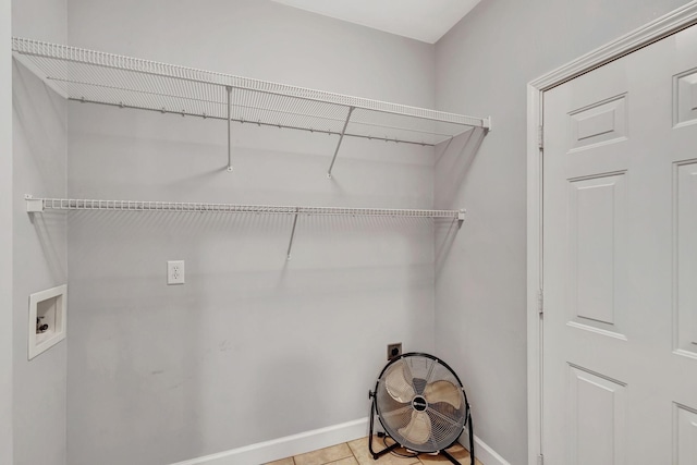 laundry area featuring washer hookup and light tile patterned floors