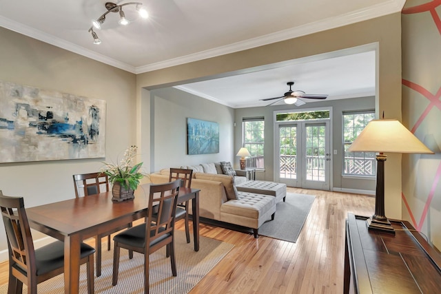 dining room featuring french doors, light hardwood / wood-style floors, ceiling fan, and ornamental molding