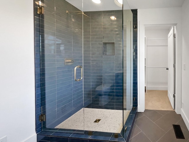 bathroom featuring tile patterned floors and an enclosed shower