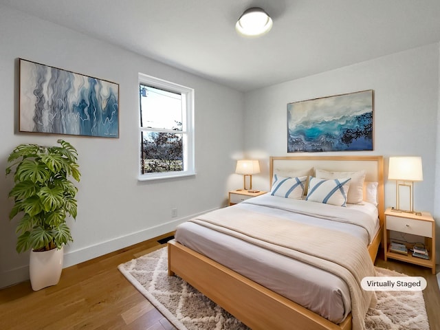 bedroom with hardwood / wood-style flooring