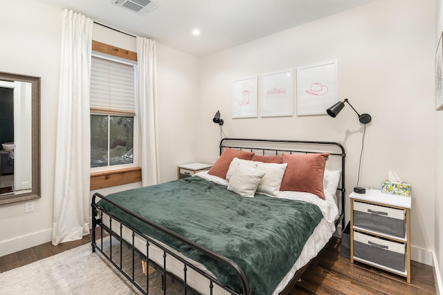 bedroom with dark hardwood / wood-style flooring