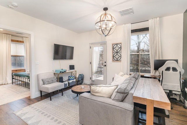 living room featuring a chandelier and hardwood / wood-style flooring