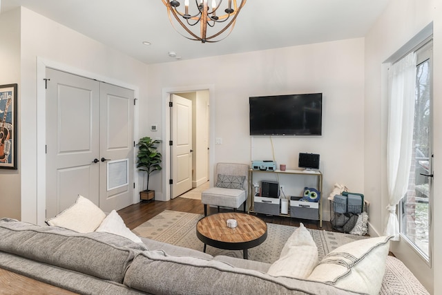 living room featuring a notable chandelier and wood-type flooring