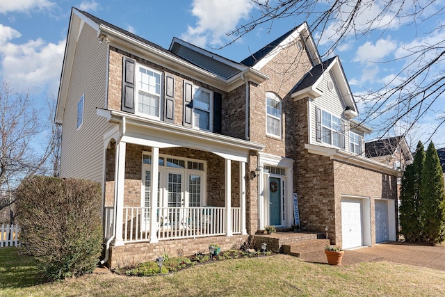 front facade with a front lawn, covered porch, and a garage