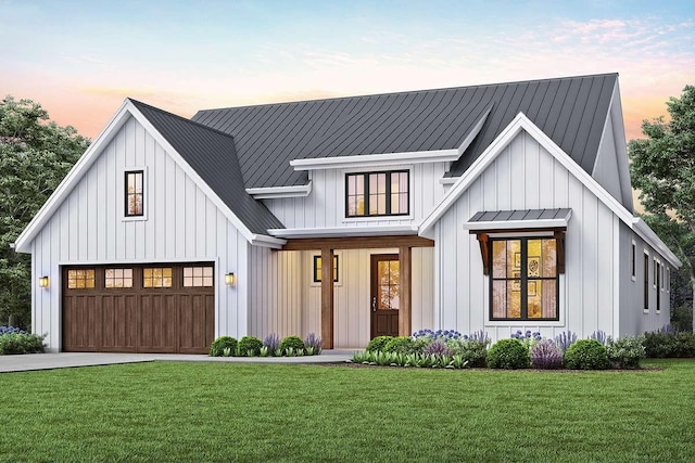 modern inspired farmhouse featuring a garage and a lawn