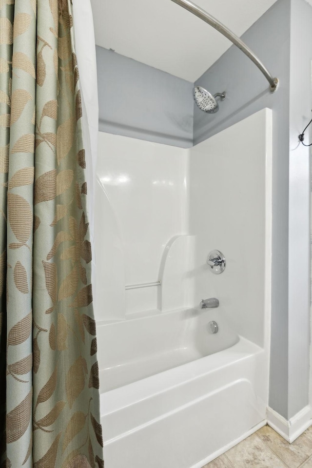 bathroom with shower / bath combination with curtain and tile patterned flooring