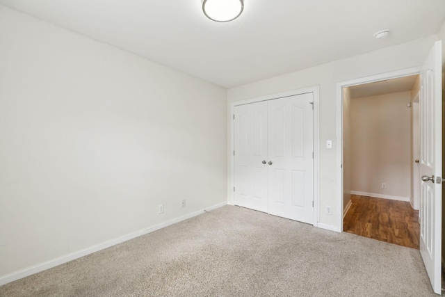 unfurnished bedroom with carpet floors and a closet