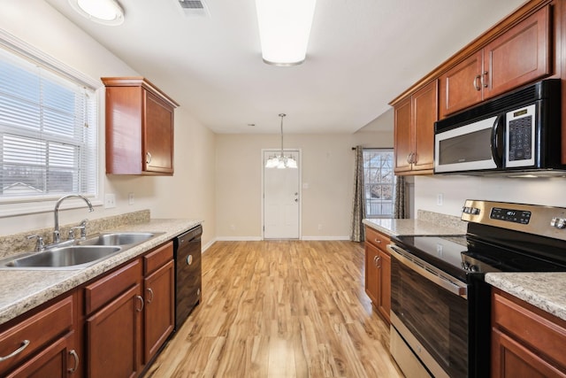 kitchen featuring sink, hanging light fixtures, black dishwasher, light hardwood / wood-style floors, and stainless steel electric stove