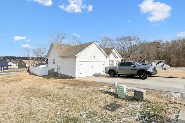 view of property exterior with a garage and a lawn