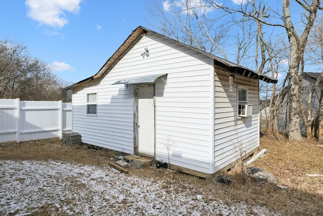 snow covered house featuring cooling unit