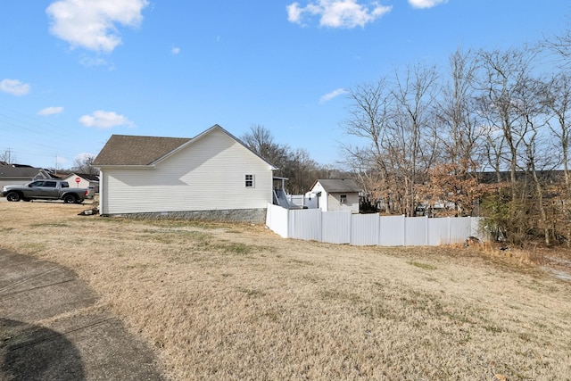 view of side of property featuring a yard