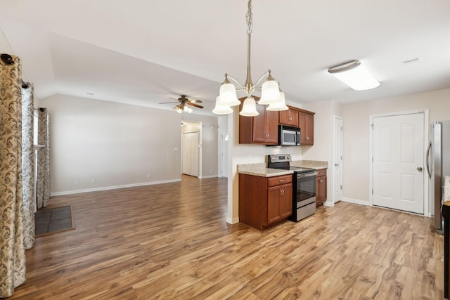 kitchen with ceiling fan, appliances with stainless steel finishes, light hardwood / wood-style floors, and decorative light fixtures