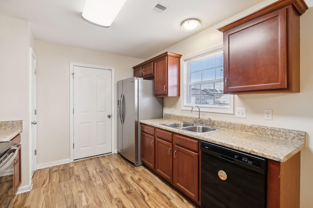 kitchen with sink, stainless steel appliances, and light hardwood / wood-style floors