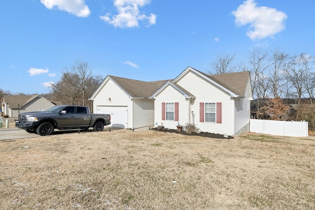 single story home with a garage and a front lawn