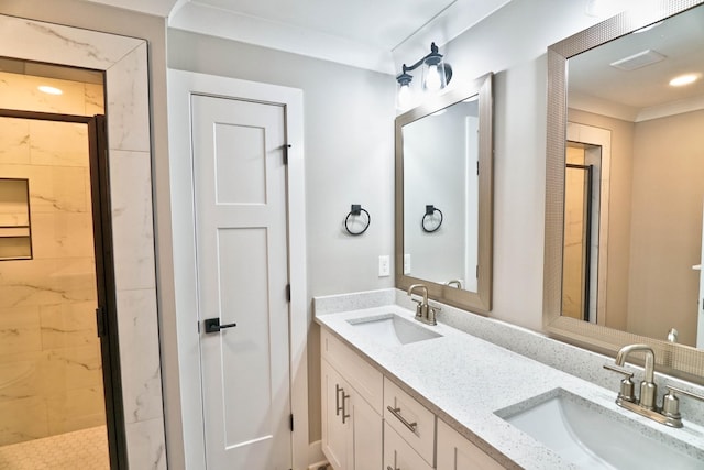 bathroom with vanity, an enclosed shower, and crown molding