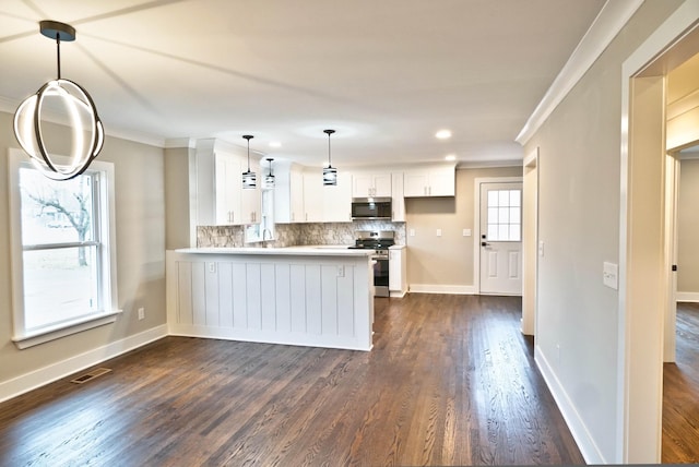 kitchen featuring crown molding, kitchen peninsula, appliances with stainless steel finishes, tasteful backsplash, and white cabinetry