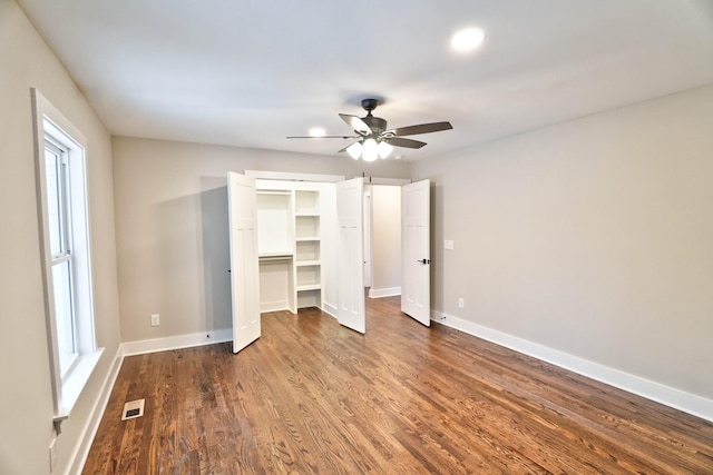 unfurnished bedroom with ceiling fan and hardwood / wood-style floors