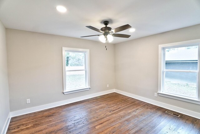 unfurnished room with ceiling fan and dark wood-type flooring