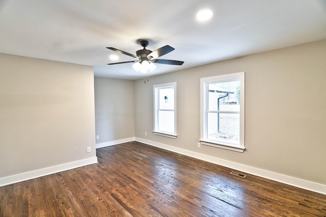 unfurnished room featuring ceiling fan and dark hardwood / wood-style flooring