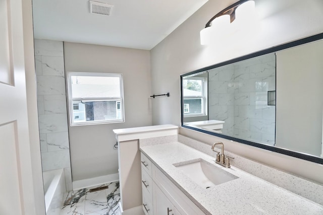 bathroom featuring washtub / shower combination and vanity