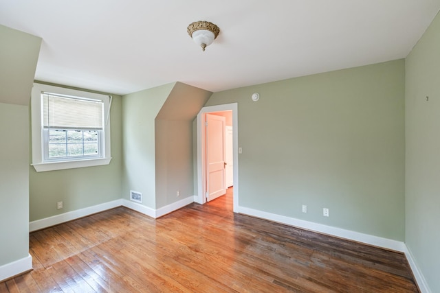 bonus room featuring hardwood / wood-style floors and lofted ceiling