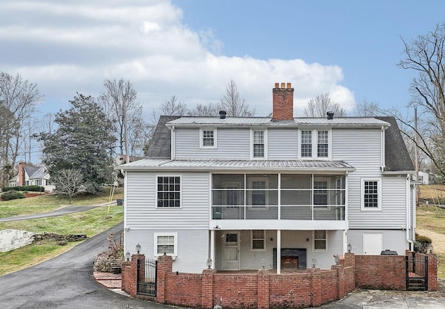 back of house with a sunroom