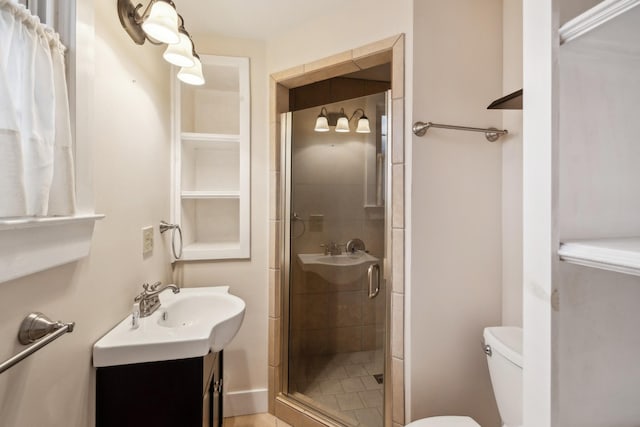 bathroom featuring vanity, toilet, and an enclosed shower