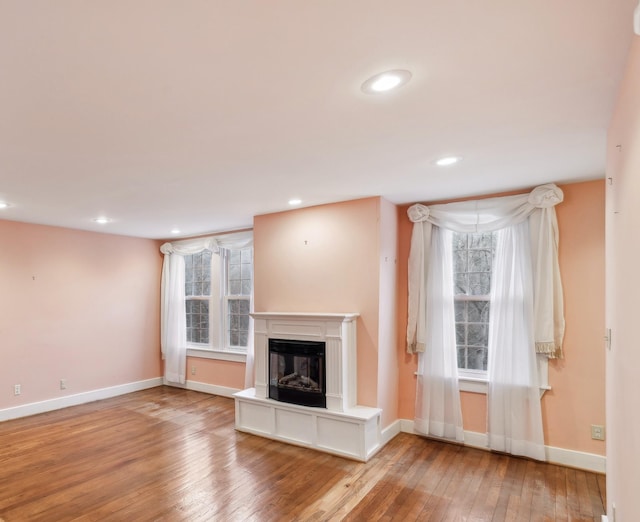 unfurnished living room featuring hardwood / wood-style flooring