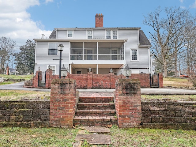 back of property with a sunroom