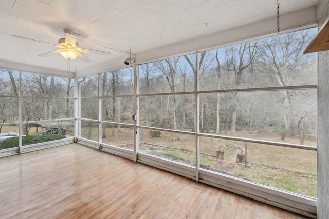 unfurnished sunroom featuring ceiling fan