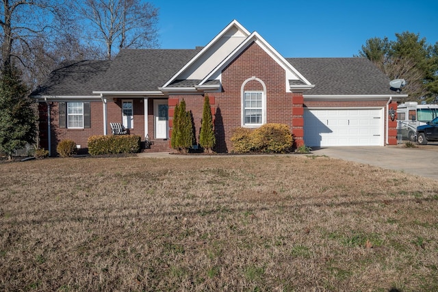 view of front of home featuring a porch, a garage, and a front yard