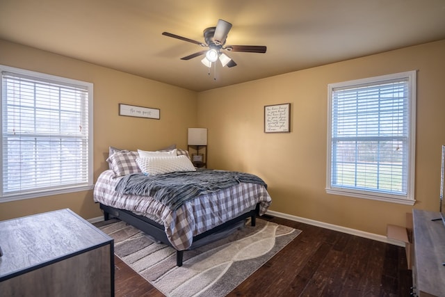 bedroom with ceiling fan and dark hardwood / wood-style flooring