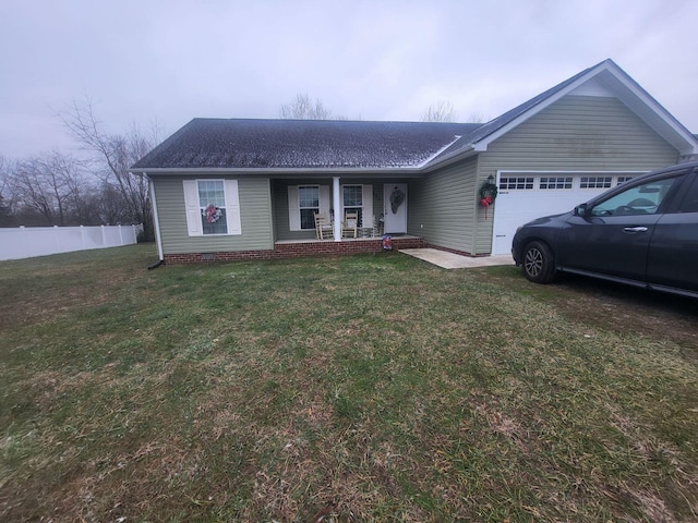 ranch-style home featuring a front yard, a garage, and covered porch