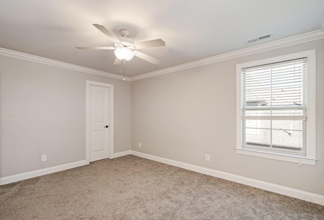 spare room featuring ceiling fan, light colored carpet, and ornamental molding