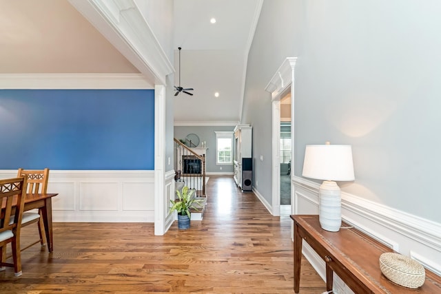 hallway with hardwood / wood-style flooring and ornamental molding