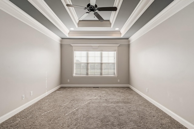 carpeted spare room featuring a raised ceiling, ceiling fan, and crown molding